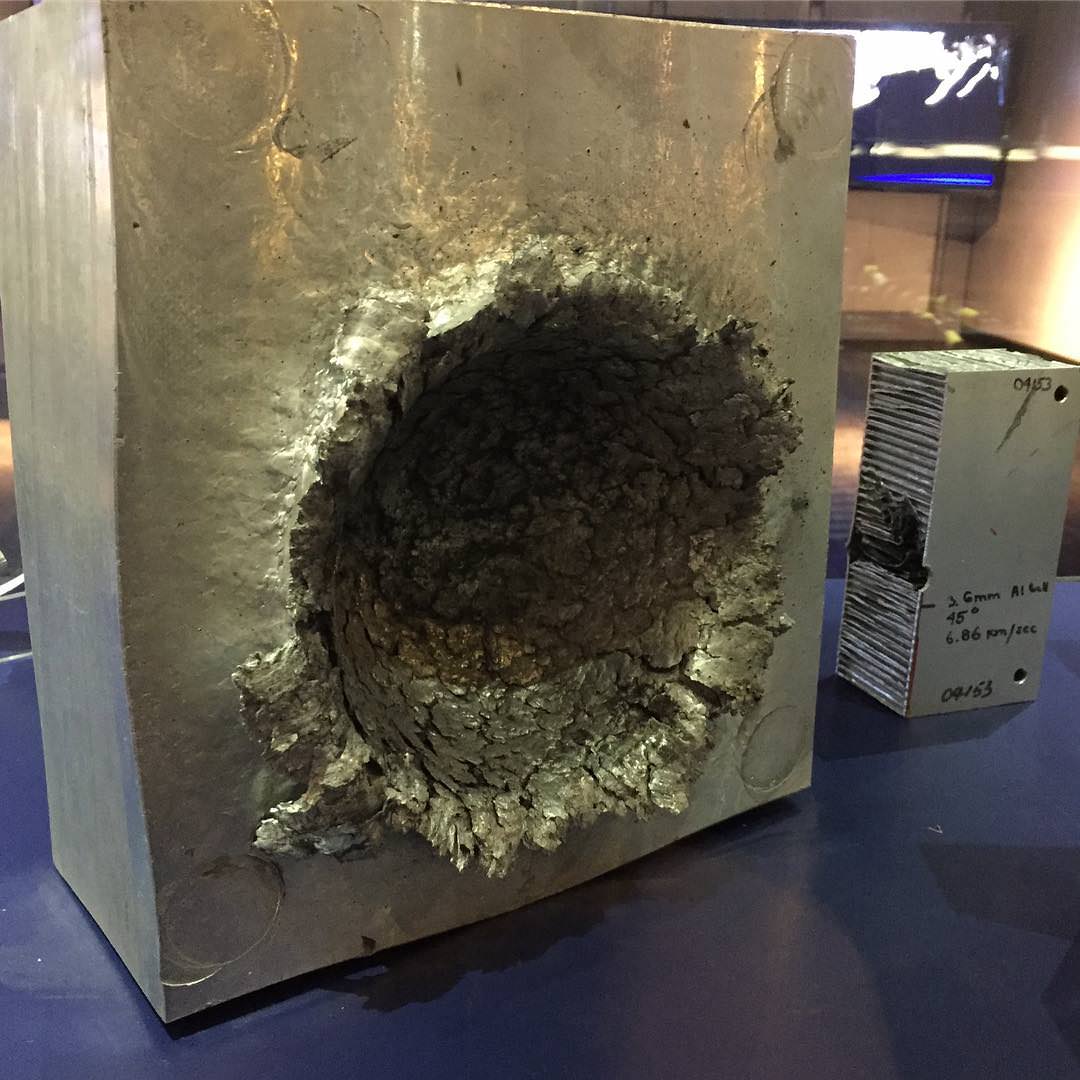 This is what happens to aluminium when a 0.5 oz piece of plastic hits it at 15000 mph in space.jpg
